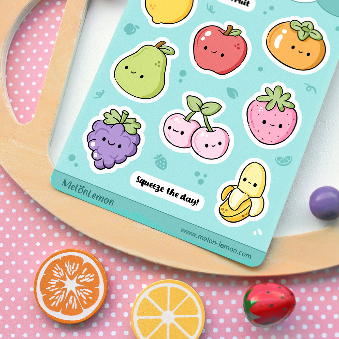 Hand drawn stickers sheet with fruit items on a turquoise blue background. Lemon, apple, persimmon, pear, strawberry, banana, grape, cherry.
