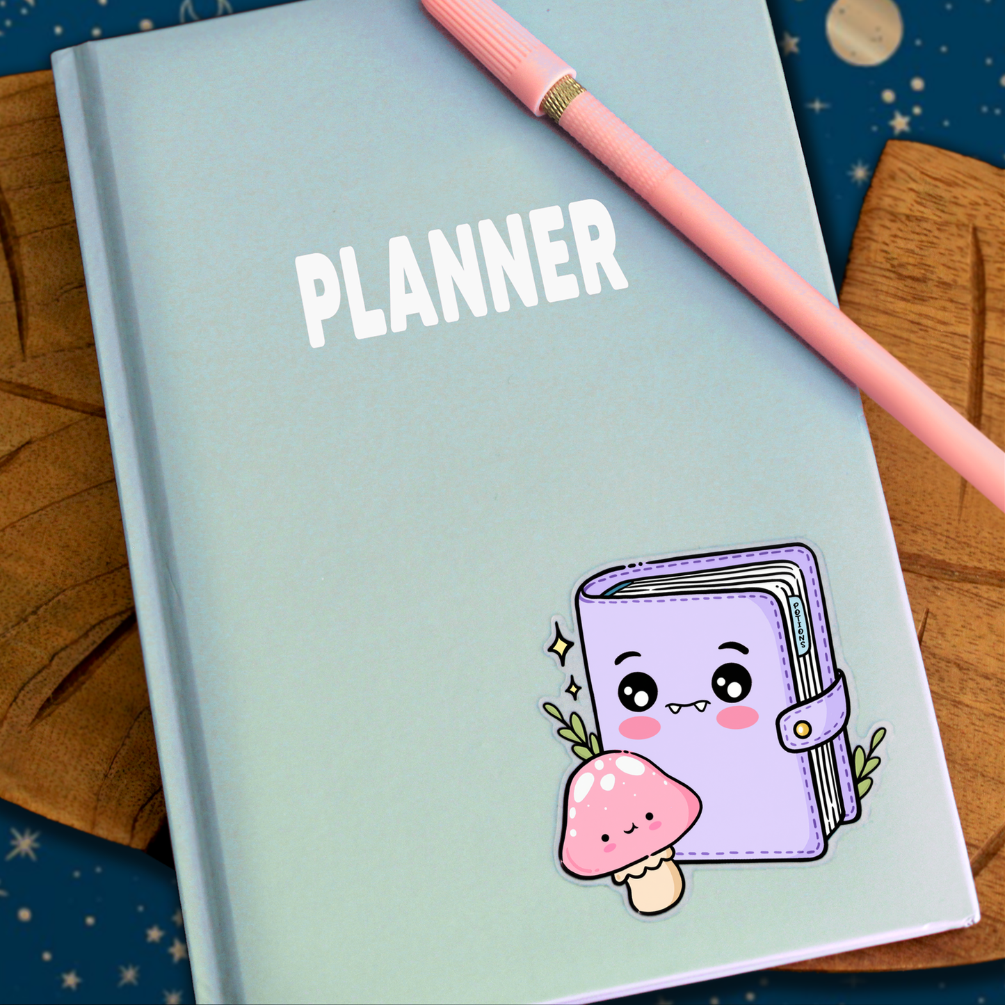 Hand drawn vinyl sticker on a planner of a potions recipe book as a kawaii character with a mushroom and herbs