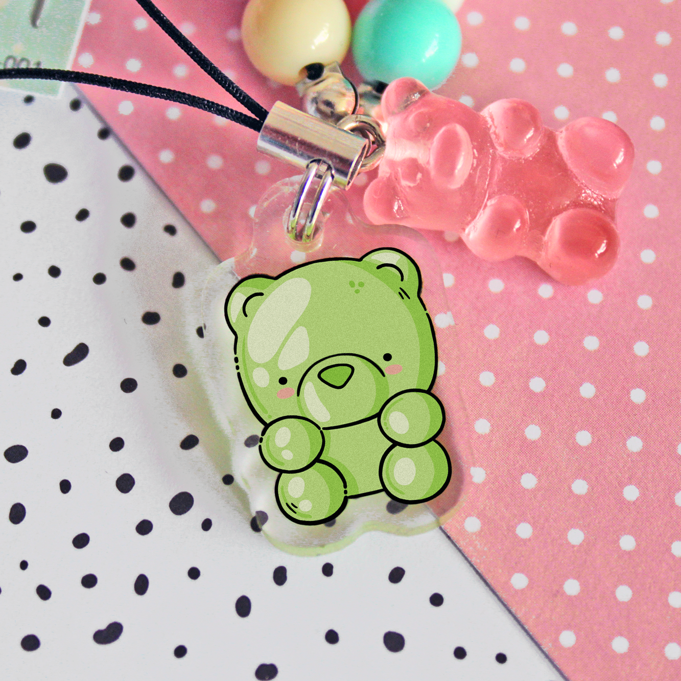 Phone strap made out of colored beads and an acrylic gummy bear charm