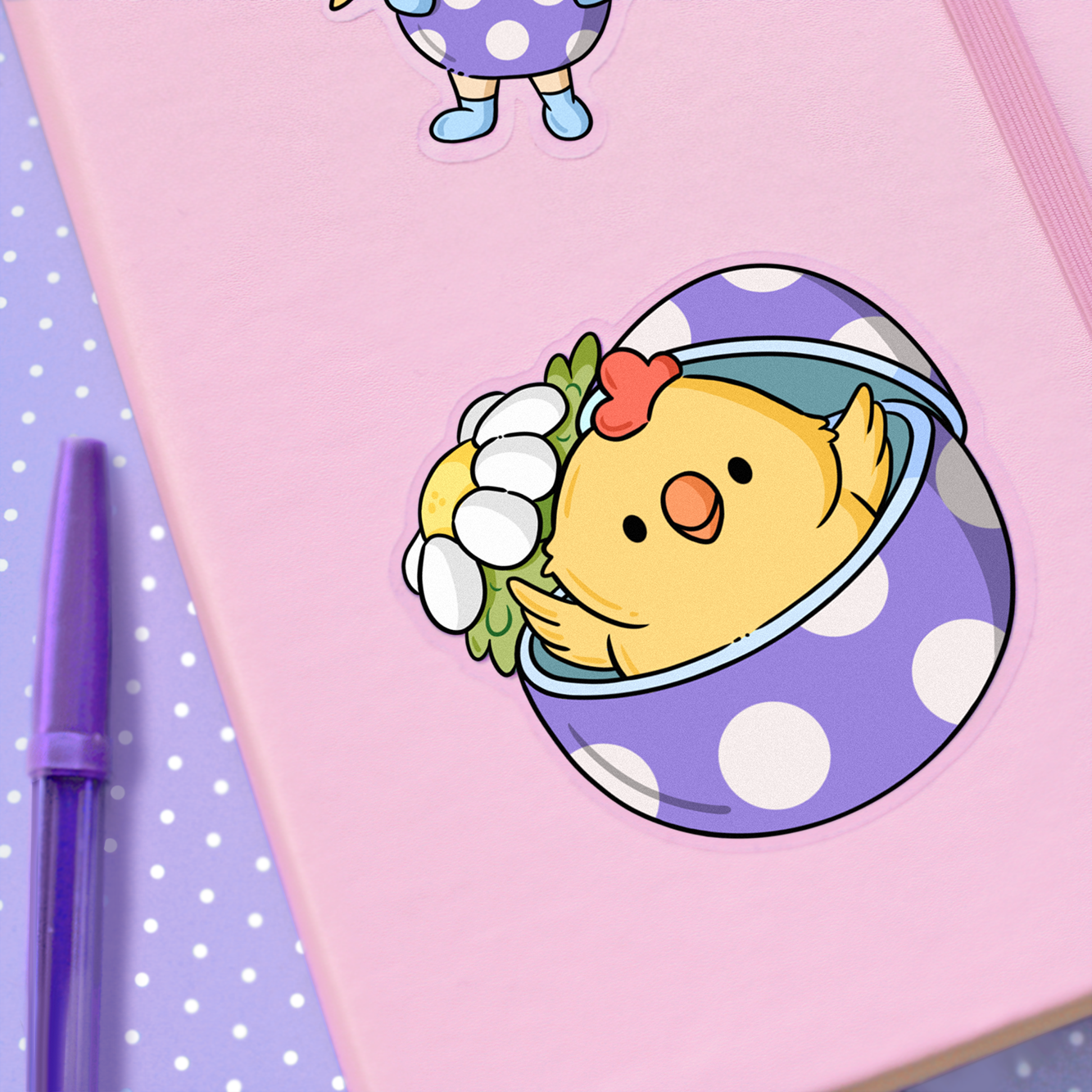 Hand drawn vinyl sticker of a kawaii chicken in a purple egg with polka dots and a daisy on a planner